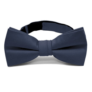 A solid color pre-tied bow tie in navy blue