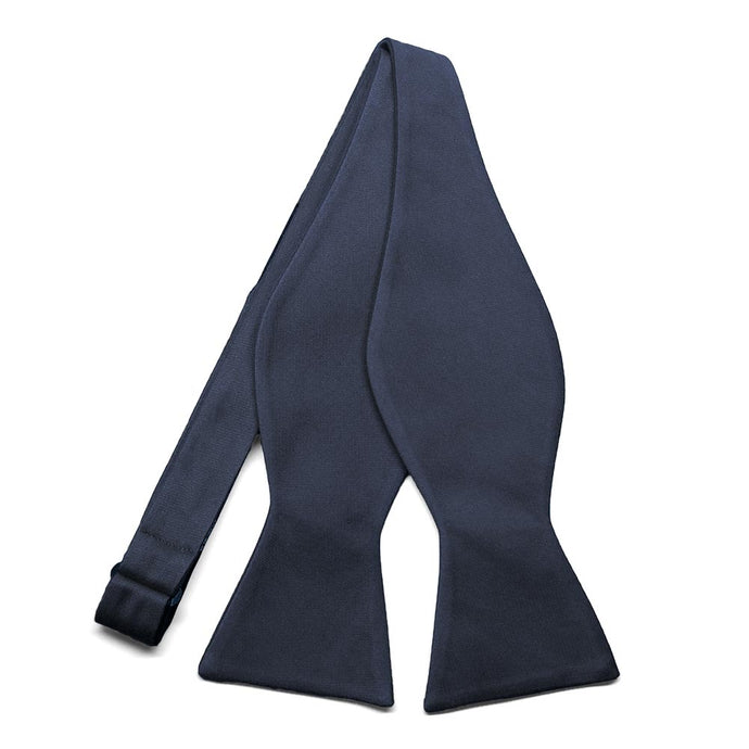 An untied solid navy blue self-tie bow tie