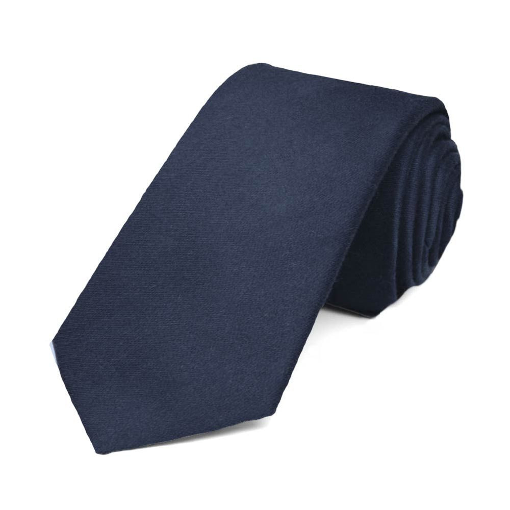 A rolled navy blue narrow necktie