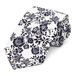 A navy blue and white floral tie, rolled