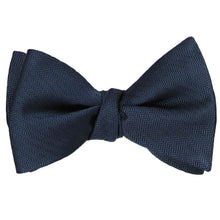 Load image into Gallery viewer, A tied navy blue silk self-tie bow tie in a tone on tone herringbone pattern
