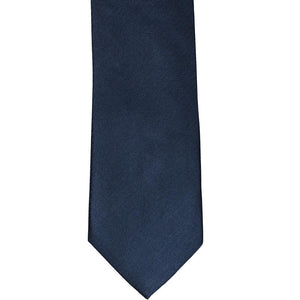 The front of a navy blue herringbone tie, laid out flat