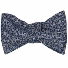 Load image into Gallery viewer, A tied self-tie bow tie in a small navy blue vine pattern