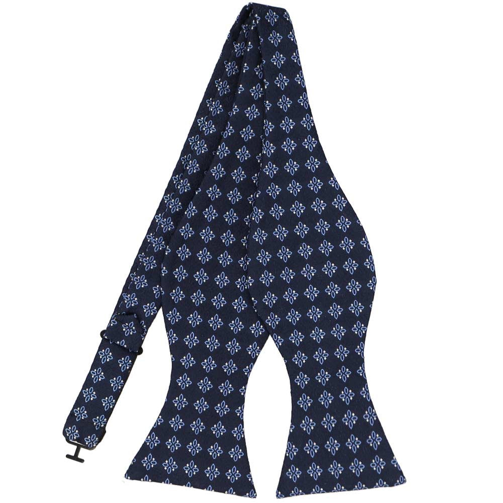 An untied navy blue self-tie bow tie with a small detailed blue geometric pattern