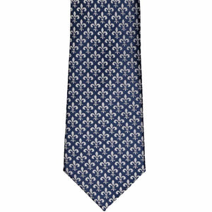 The front of a navy tie with a gray fleur de lis pattern