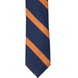 The front of a navy tie with orange ribbed stripes