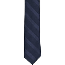 Load image into Gallery viewer, The front of a navy blue tone-on-tone striped tie, laid out flat