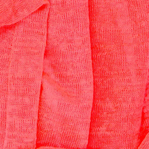 A closeup of the material on a fluorescent pink infinity scarf