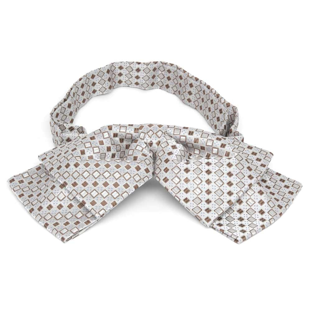 Off-white and tan square pattern floppy bow tie, close up front view