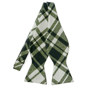 An untied dark green and white plaid self-tie bow tie  Edit alt text
