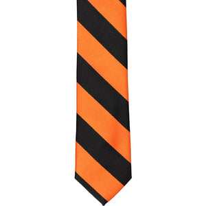 The front of an orange and black striped skinny tie, laid out flat