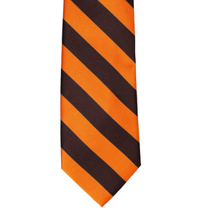 The front of an orange and brown striped tie, laid out flat