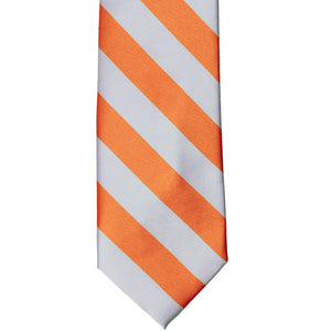 The front of a silver and orange striped tie, laid out flat