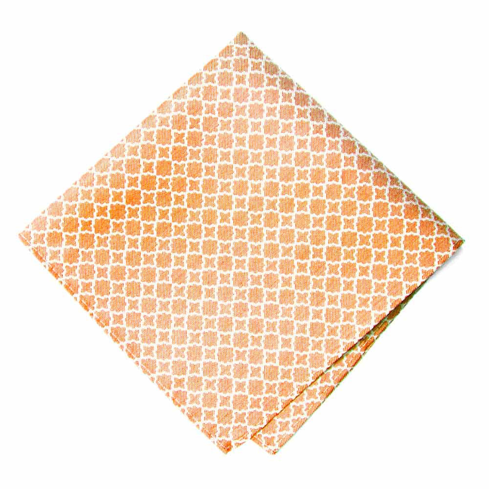 A folded orange pocket square with a white trellis pattern