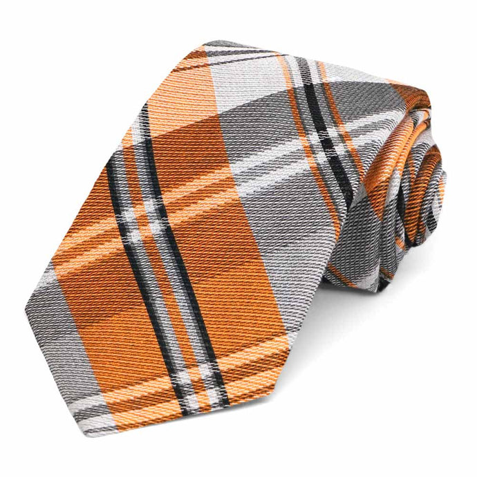 Orange and gray plaid necktie, rolled to show the woven texture