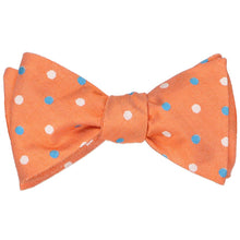 Load image into Gallery viewer, A tied self-tie bow tie in an orange polka dot pattern