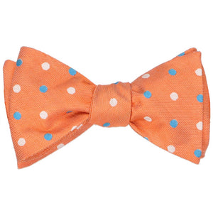 A tied self-tie bow tie in an orange polka dot pattern