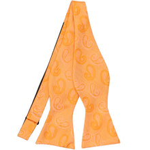 Load image into Gallery viewer, An orange tone-on-tone self-tie bow tie, untied, in a paisley pattern