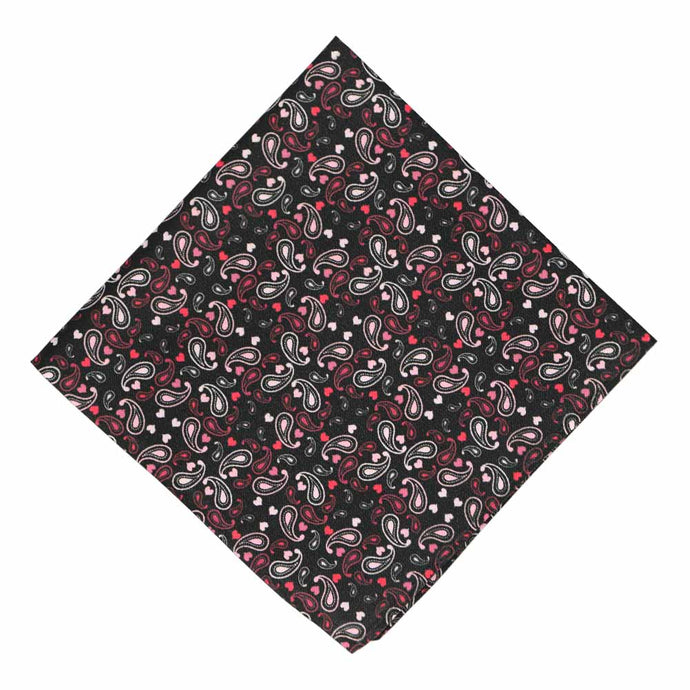 A black pocket square with a paisley and heart pattern in shades of red and pink
