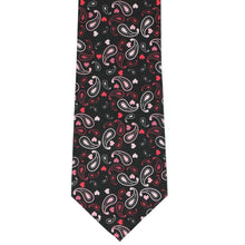 Load image into Gallery viewer, The front of a black flat displayed tie with a heart paisley pattern