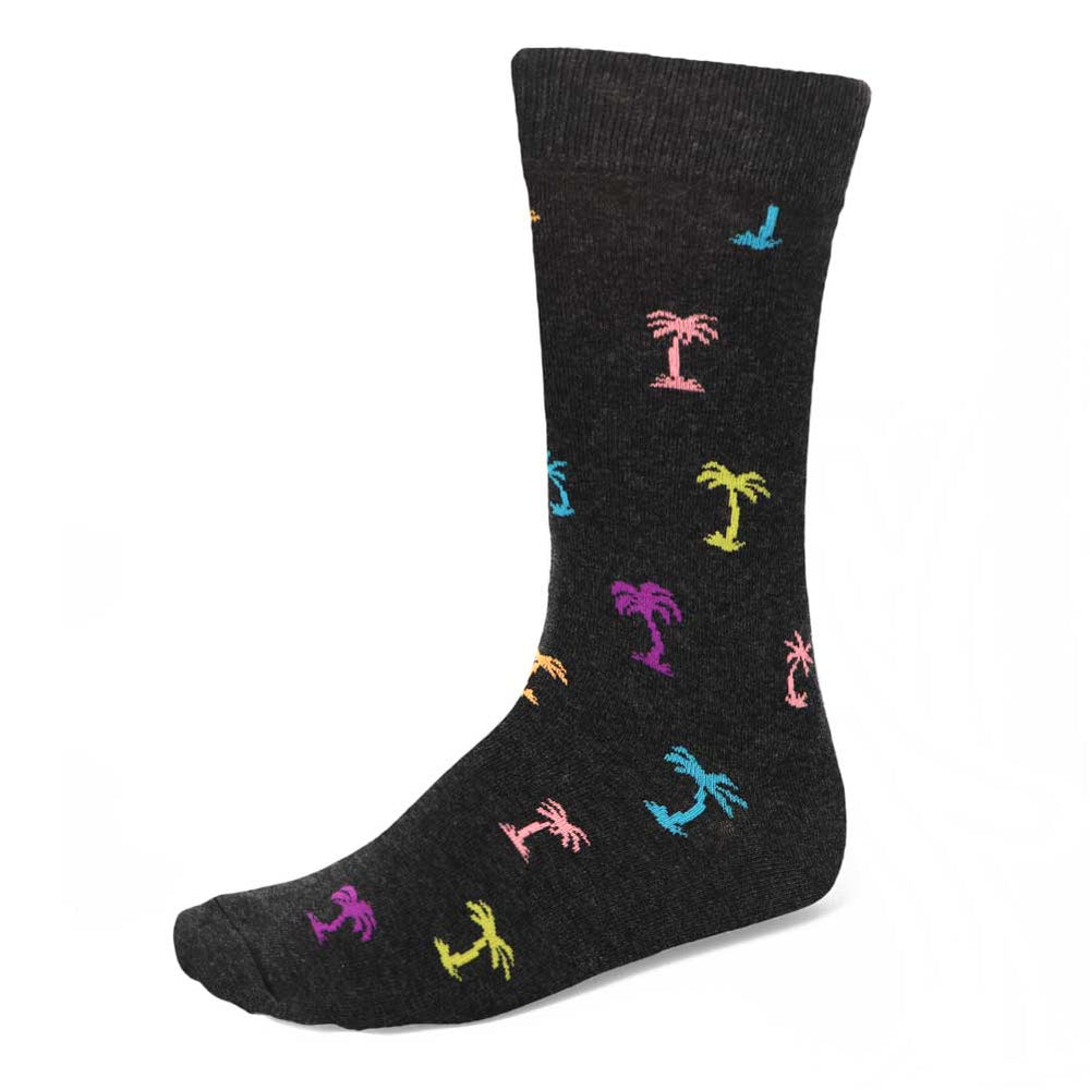 A pair of men's black heathered socks with a colorful all over palm tree pattern