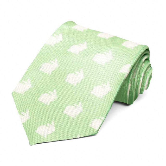 A rolled pear green tie with a white bunny pattern