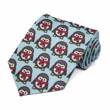 Load image into Gallery viewer, Penguins with red scarves on a light blue tie.
