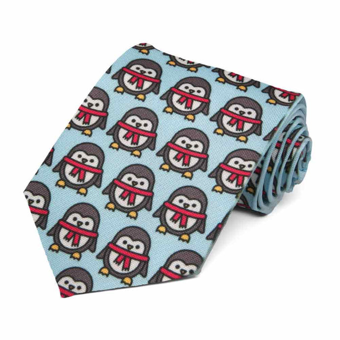 Penguins with red scarves on a light blue tie.