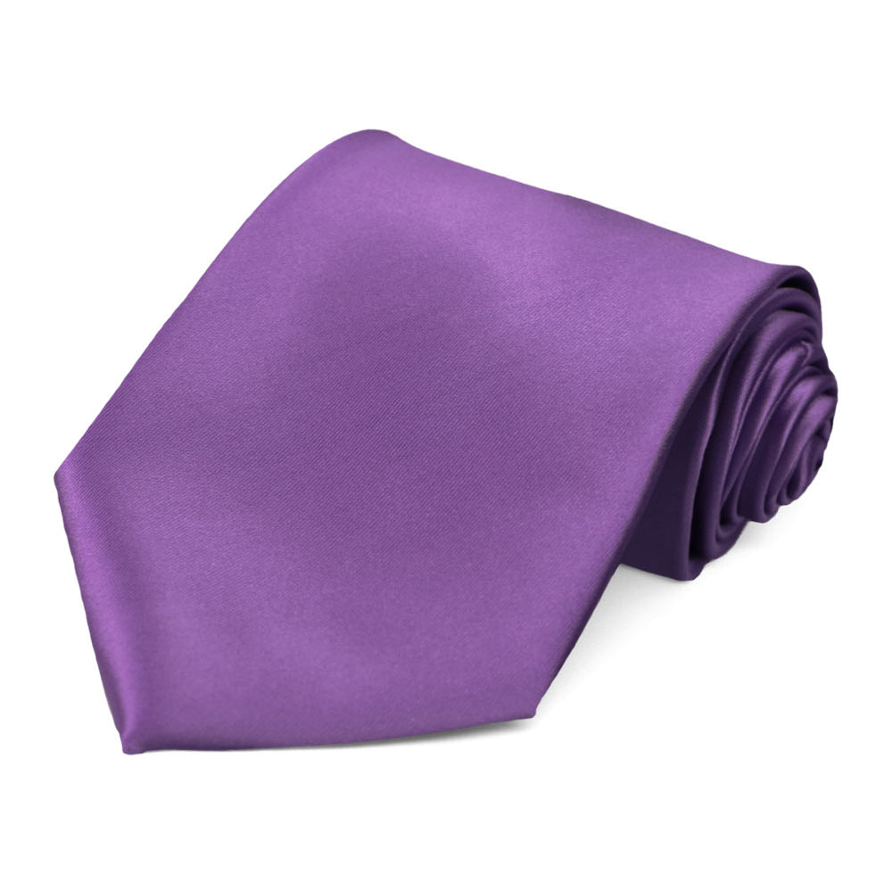 A rolled solid color purple tie