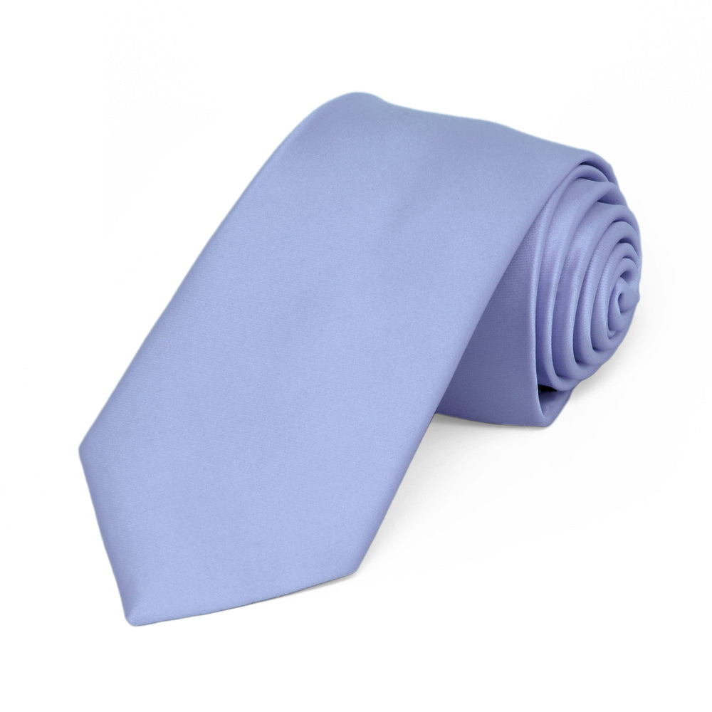 A periwinkle solid tie, rolled, in a slim width