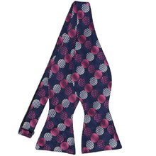 Load image into Gallery viewer, A pink and navy blue large dotted pattern self-tie bow tie, untied