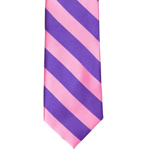 The front of a pink and purple striped tie, laid out flat