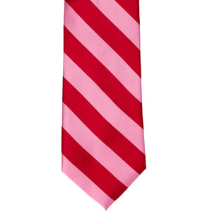 The front of a pink and red striped tie, laid out flat