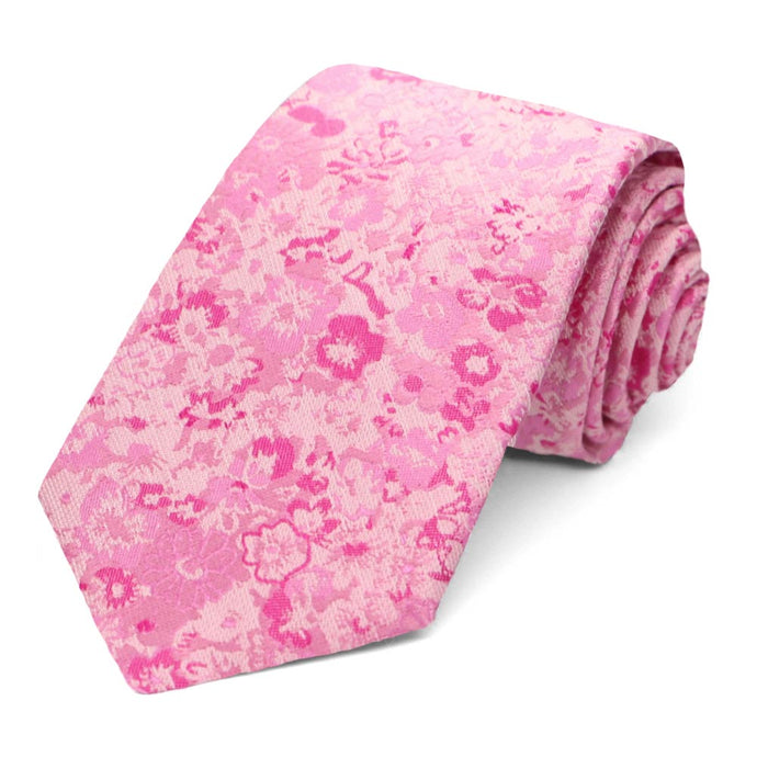 A pink tie with a small floral textured pattern 