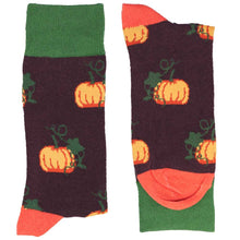 Load image into Gallery viewer, A folded pair of socks with an orange and green pumpkin pattern