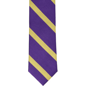 Front, bottom view of a purple and gold striped narrow tie