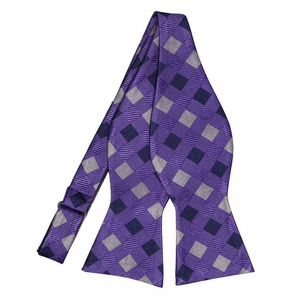 An untied purple and gray checkered self-tie bow tie