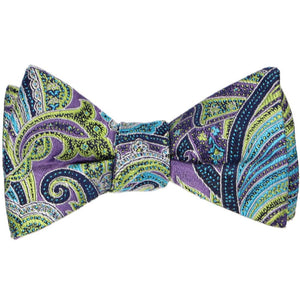A tied self-tie bow tie in a purple, lime and turquoise paisley pattern