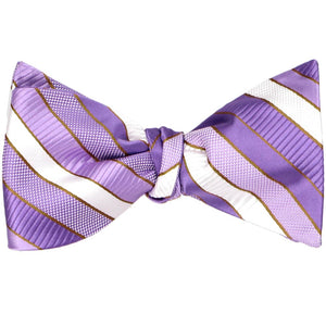 A purple striped self-tie bow tie, tied