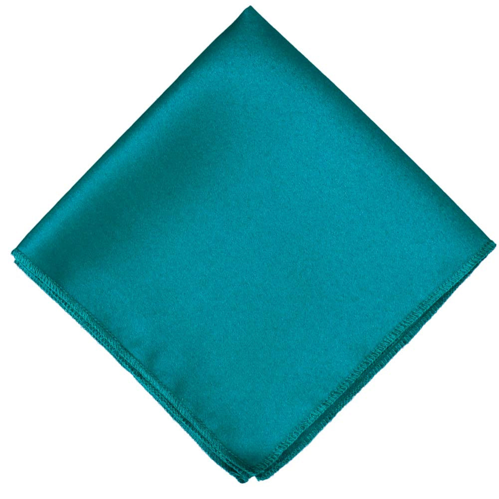 A teal blue colored pocket square, folded into a diamond