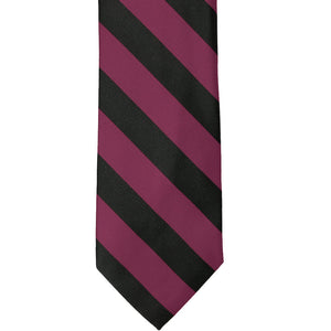 The front of a raspberry and black striped tie, laid out flat