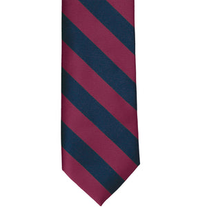The front view of a raspberry and navy striped tie
