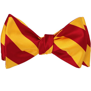 A red and golden yellow striped self-tie bow tie, tied