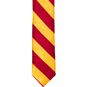 The front of a red and golden yellow striped tie, laid out flat