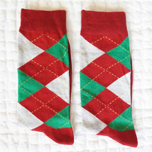 Load image into Gallery viewer, A pair of red and green argyle socks on top of a white textured background
