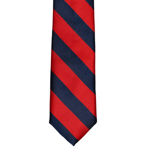 The front of a red and navy blue striped tie, laid out flat