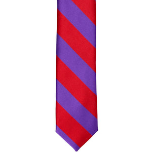 The front of a red and purple striped skinny tie, laid out flat