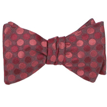 Load image into Gallery viewer, A tied self-tie bow tie in a crimson red tone-on-tone polka dot pattern