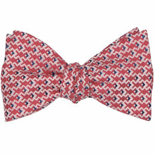 Load image into Gallery viewer, A tied self-tie bow tie in a red, white and blue geometric pattern