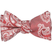 Load image into Gallery viewer, A tied self-tie bow tie in a red and white paisley pattern with some texture